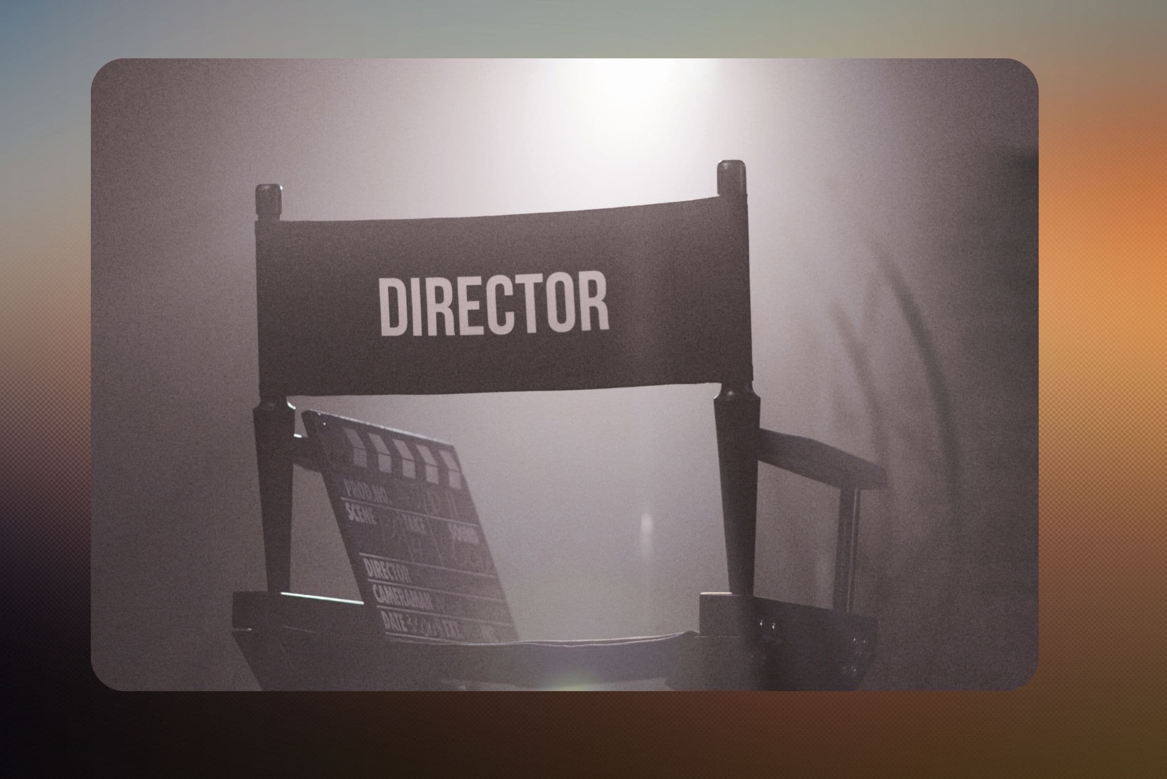 A director's chair and a clapperboard under a soft spotlight